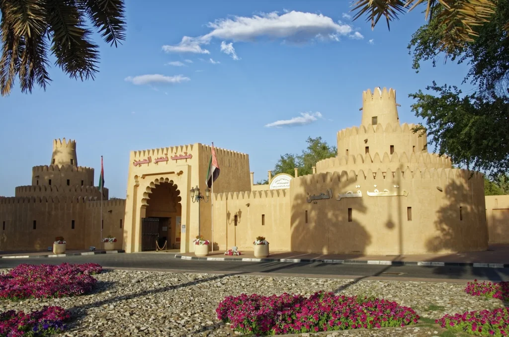 a building with towers and flowers